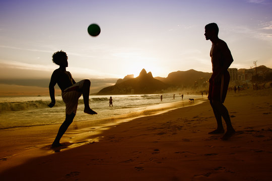 Men playing ball at beach