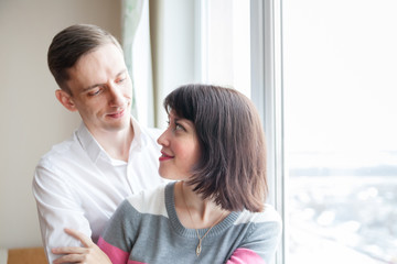 couple standing   at   window.