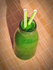 Green smoothie in jar with straws. Healthy breakfast concept