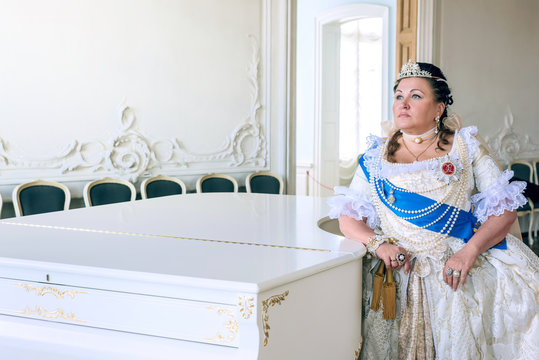 Historical cosplay. Beautiful woman in the similitude of Catherine the Great, empress of Russia ancient dress in the palace