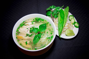 Pho ga or Vietnamese rice noodle soup with sliced chicken