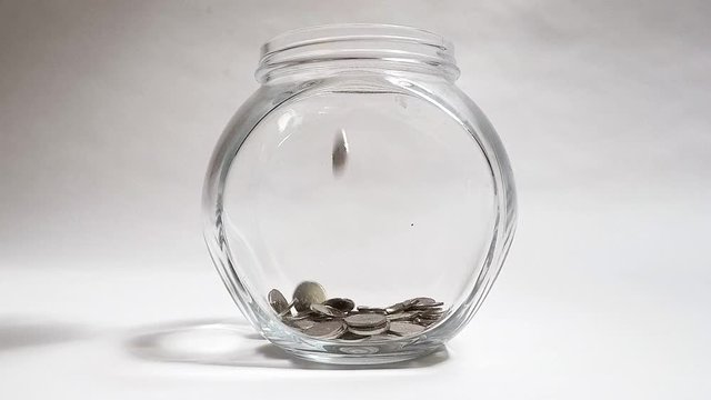 Silver coins falling to dish. Economic and financial theme. Money for you. 
