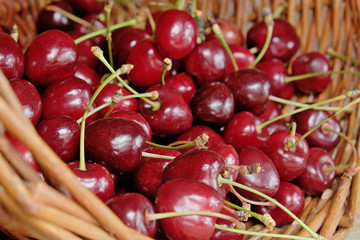 Ripe cherries in a wicker basket