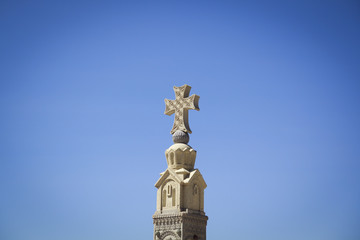 Fototapeta na wymiar Stone Christian Cross on the top of column