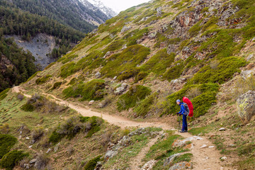 Naklejka premium Woman mountain Hiker with backpack enjoy view in Caucasus mountains, Elbrus region, Russia.