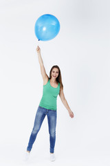 Portrait of young woman floating with balloon