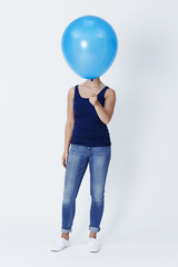 Blue balloon obscures model's face in studio