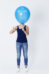 Young woman with thumbs up for balloon