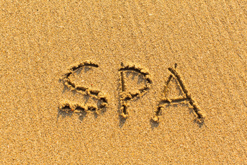 SPA - word drawn on the sand beach.