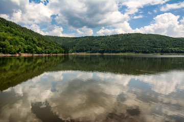 Fototapeta na wymiar Beautiful summer day by the lake with a cloudy sky in the Carpathian mountains