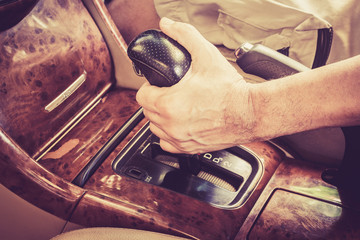 Man driver hand shifting the gear stick