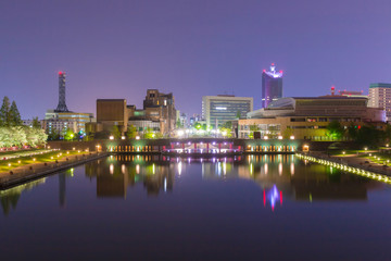 Beautiful architecture building and colorful bridge in twilight