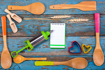 Set kitchen utensils and a notebook for recipes