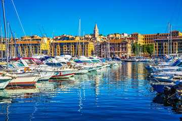 Rows of sailing yachts and fishing boats