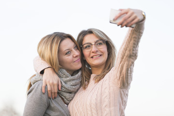 Blonde sisters taking selfie