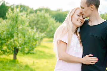 Couple standing in park and hugging