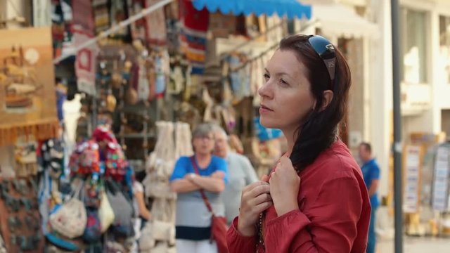 Heraklion, Greece, woman tourist is choosing souvenirs. Concept of tourism.