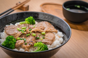 Roasted pork with stir fried broccoli and japanese rice in bowl