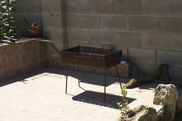 outdoor brazier with coal on the sunny courtyard