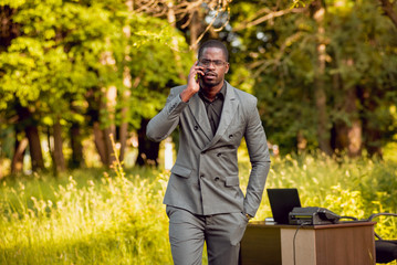 Young businessman at work in the park.