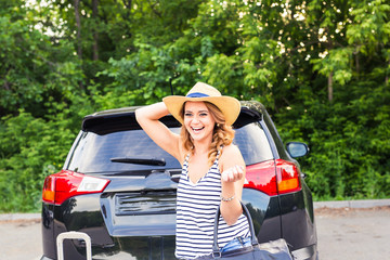 Young woman with suitcases. Vacation concept. Car trip. Summer travel.