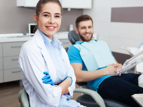 Portrait of a female dentist and young happy  male patient.