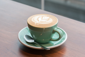 cup of coffee on wood table
