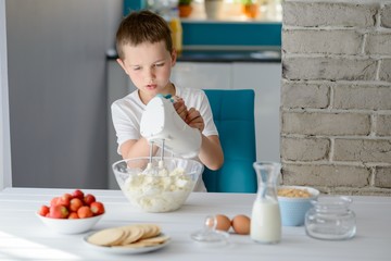 Child mixing with electric mixer white cottage cheese