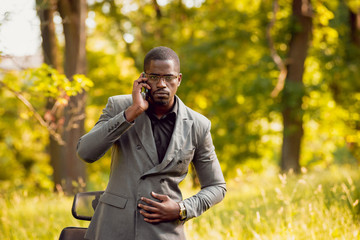 Young businessman at work in the park.