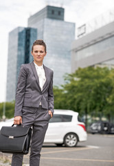 Portrait of business woman with briefcase at office district