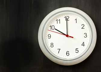 'Beginning of workday' or 'time' concept: white clock with copyspace