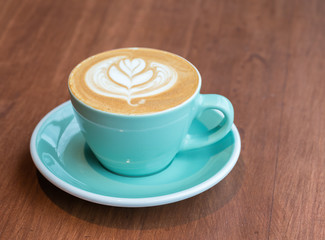 cup of coffee on wood table
