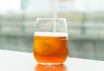 glass of ice coffee on wood table
