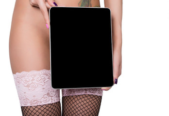 technology, internet and networking - close-up ass of girl in lacy lingerie, holding a tablet pc...