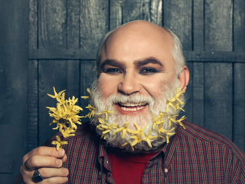 old man with flowers in beard