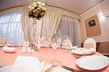Table in a restaurant with glasses, napkins and cutlery