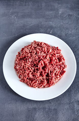 Obraz na płótnie Canvas Raw ground beef on a white plate