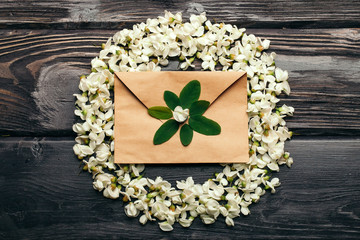 Envelope and wreath of acacia