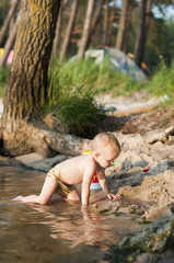 child  bathes in the river