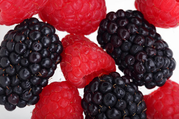 raspberry and blackberry on white background.