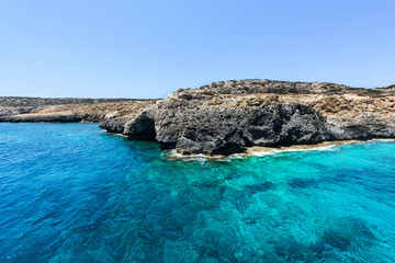 Fototapeta premium Pirate bay in protaras paralimni, white church, blue sea and rocks, cyprus island