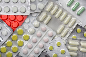 Different pills blisters as background.