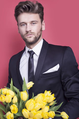 Man holding yellow tulips