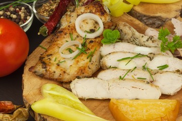 Grilled chicken steak with spices and vegetable. Dietary food for athletes. Healthy diet meals. Fried chicken. Steak ready for the grill.
