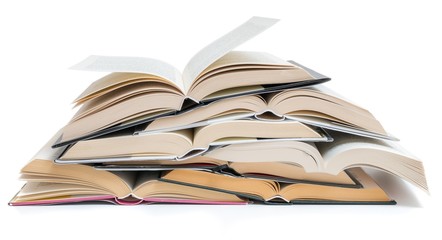 Many opened stacked books isolated on white background.