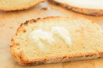 Melting butter on a slice of rustic toasted bread