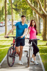 Cycling young couple.