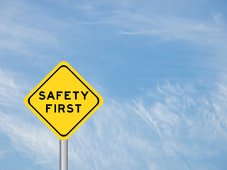 wording "Safety first" on yellow traffic sign on the blue sky