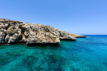 Fototapeta na wymiar Pirate bay in protaras paralimni, immaculate water, blue sea and rocks, cyprus island