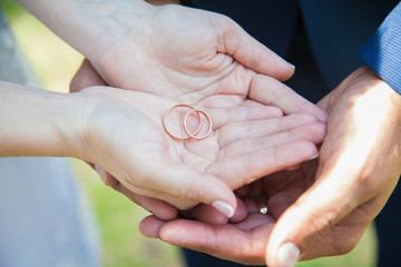 Wedding rings on the palms newlyweds